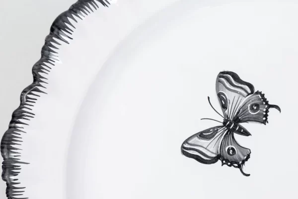 Detail of black butterfly plate